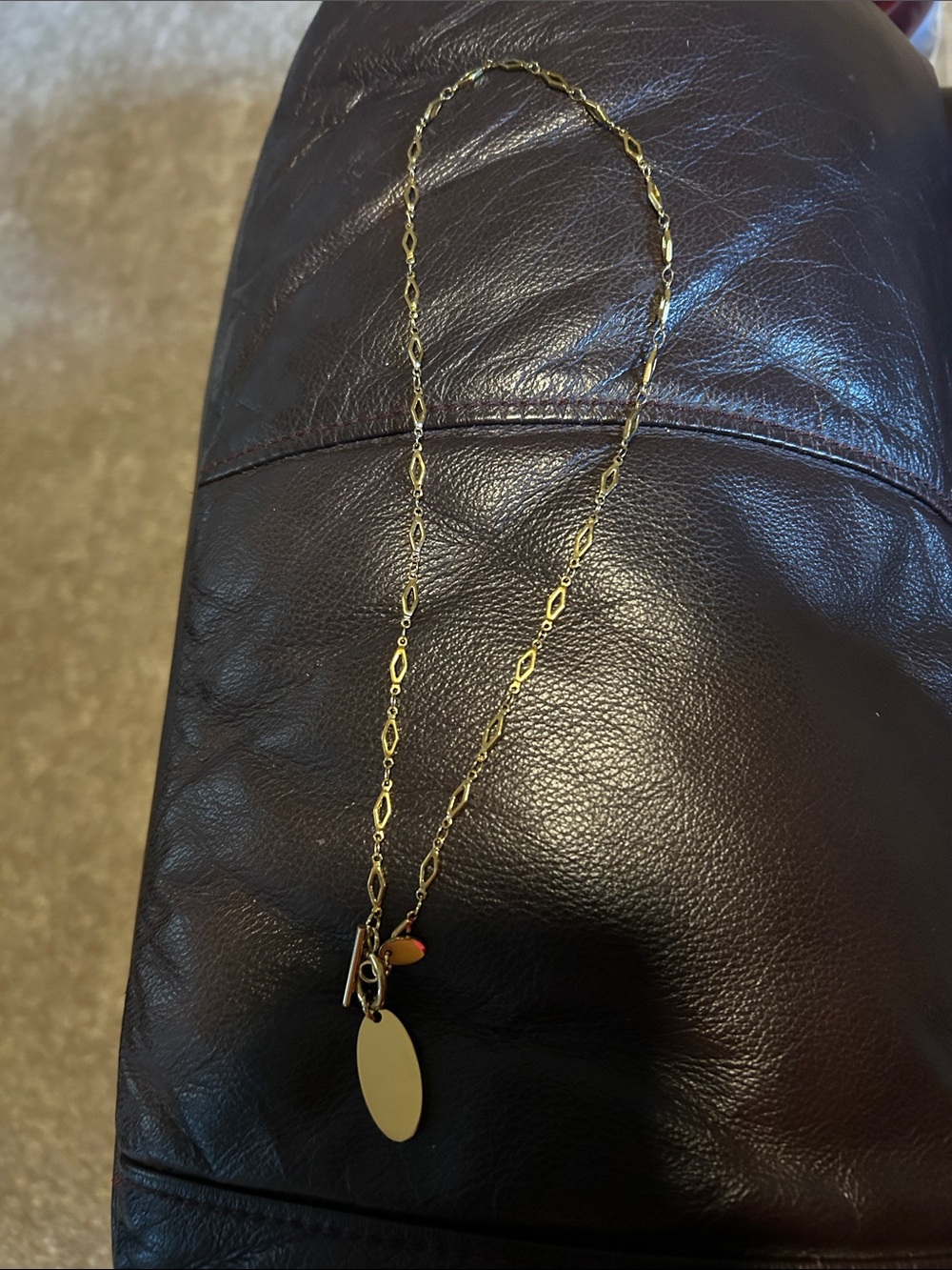 Plunder Gold Tone Oval Pendant Necklace with Small Accent Charm
